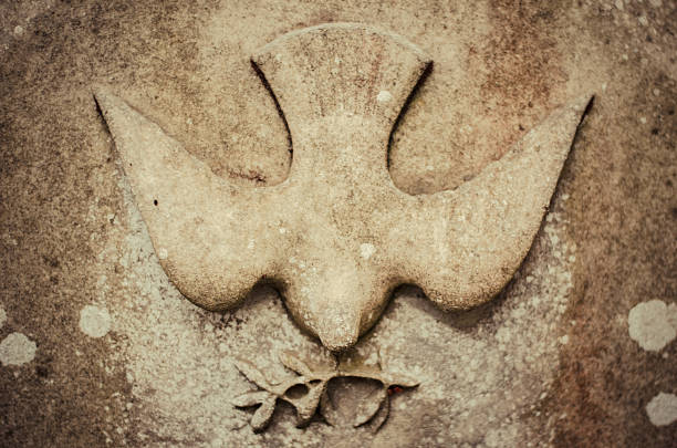 Holy Peace Relief on stone of a dove with a twig, the Christian symbol of the Holy Spirit, as well as symbolic rebirth and traditional secular symbol for peace. spirituality stock pictures, royalty-free photos & images