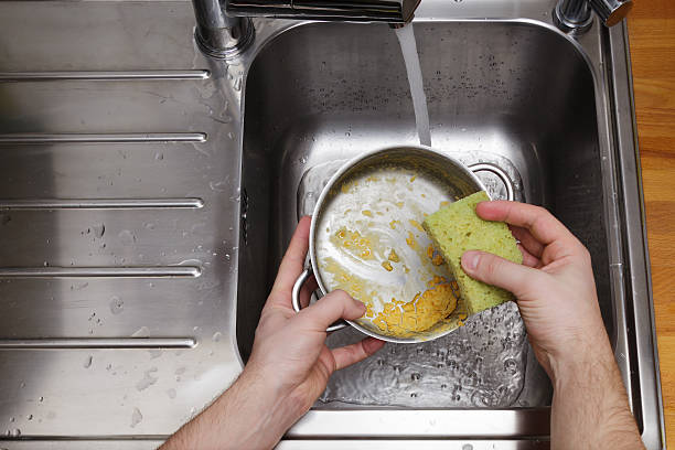 istock man washing dishes without gloves 501219470