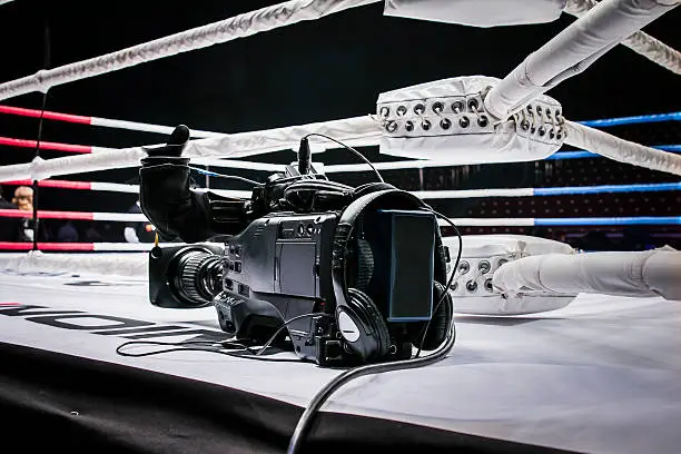 professional camcorder stands on corner ring for mixed martial arts. live broadcast competition in MMA and Boxing