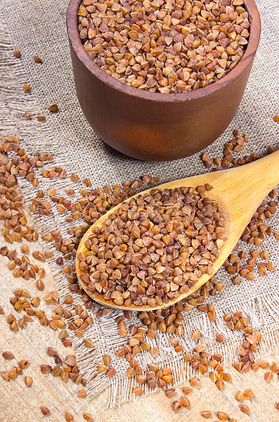 istock Buckwheat groats on a wooden spoon. 501220334
