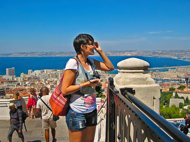 Happy tourists visiting Marseille Marseille, France - August 16, 2015: Happy tourists visiting Marseille from the observation deck of the cathedral  Notre Dame de la Garde. Marseille, France - August 16, 2015 leisure activity french culture sport high angle view stock pictures, royalty-free photos & images