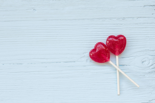 Lolly pop hearts  on a wooden background