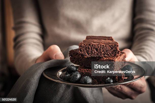 Chocolate Brownie With Blueberry In The Hands Stock Photo - Download Image Now - Affectionate, American Culture, Animal Body Part