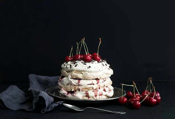 Photo of Pavlova cake with fresh cherry, cheese cream and chocolate chips