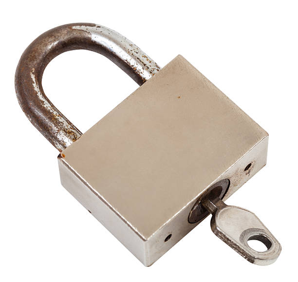 istock closed steel old padlock with key isolated 501225274