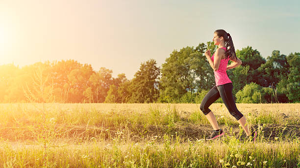 istock Attractive young female jogging in countryside 501225636