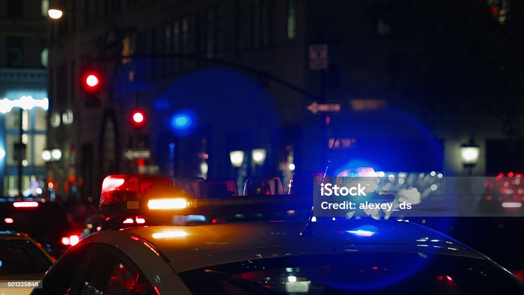 Police car with turned on siren at night street Police Vehicle Lighting Stock Photo