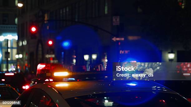 Police Car With Turned On Siren At Night Street Stock Photo - Download Image Now - Police Vehicle Lighting, Night, Blue