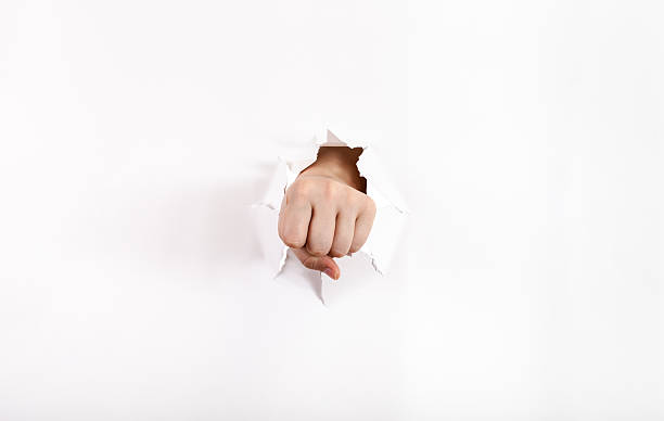 istock front view of the fist punches a paper 501227162