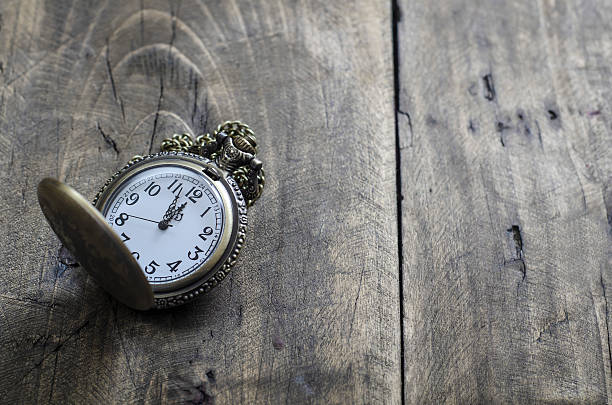 istock Pocket watch and chain against aged wood 501227484