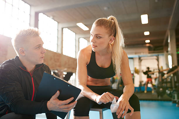 istock Personal trainer and student discussing fitness plan 501228140