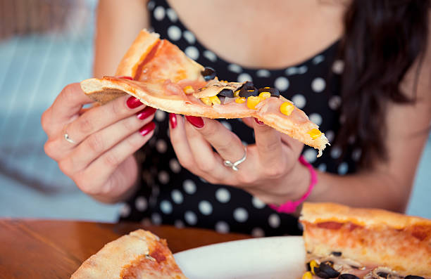 istock Anonymous woman enjoying pizza in restaurant 501228272