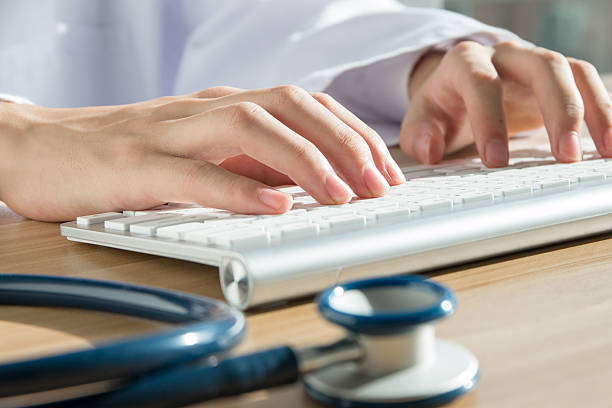 istock Close up of doctor's hand at computer typing 501228474