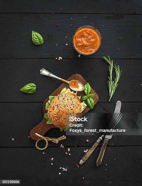 Fresh Homemade Burger On Dark Serving Board With Spicy Tomato Stock Photo - Download Image Now
