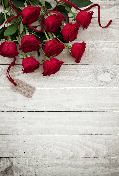 istock Valentine's day red roses bouquet on old rustic wood table 501231686