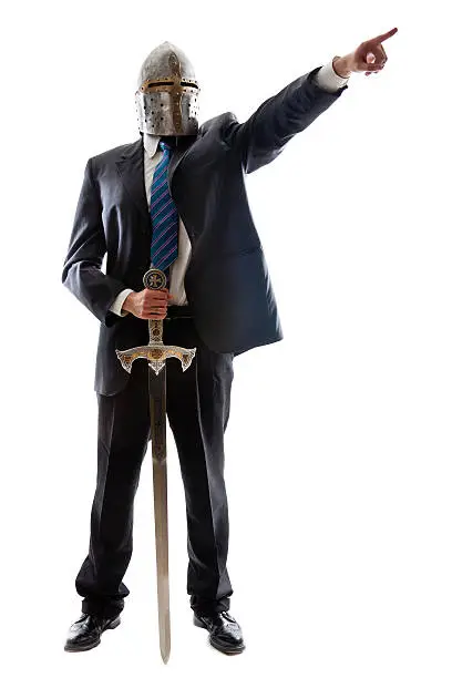 A Young Businessman isolated on a white background holding a steel sword and wearing an helm