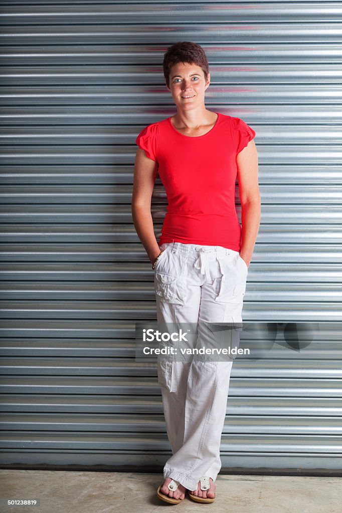 Casual Brunette Wearing White Trousers Short-haired brunette in her late thirties looking fit and healthy, shot in a casual pose. 30-39 Years Stock Photo
