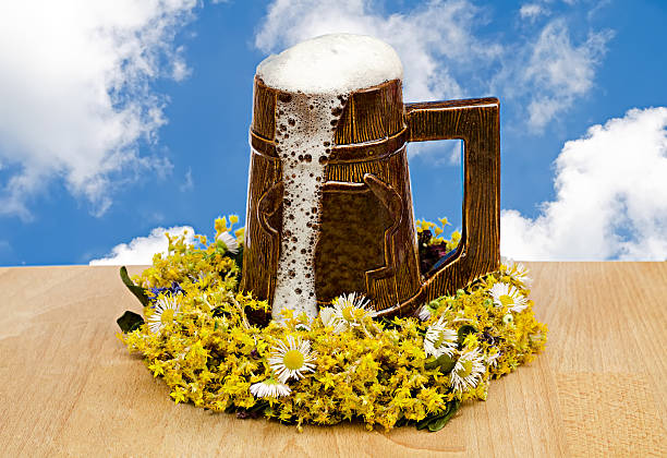 beer glass with flowers against the sky