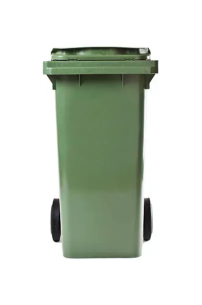 A DSLR photo of an closed green garbage bin / container with black wheels isolated on white background Indoors Studio shot