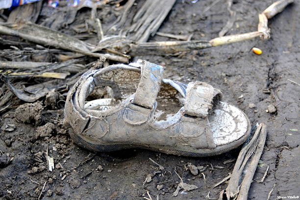 Sid, Serbia - October 2nd, 2015: Child shoe lost by Syrian refugees on their way to European Union States, on a dirt path near the Serbia - Croatia border.