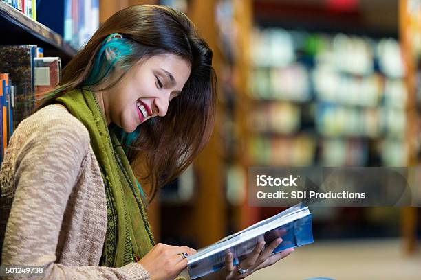 Trendy Young College Student Reading In Modern Library Stock Photo - Download Image Now