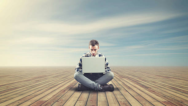 istock Young man sitting on a wooden floor 501253976