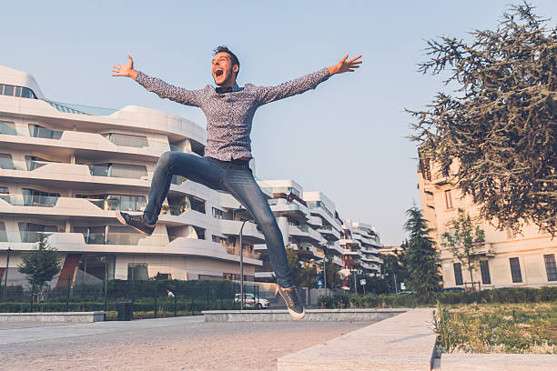 istock Young handsome man jumping in the city streets 501255024