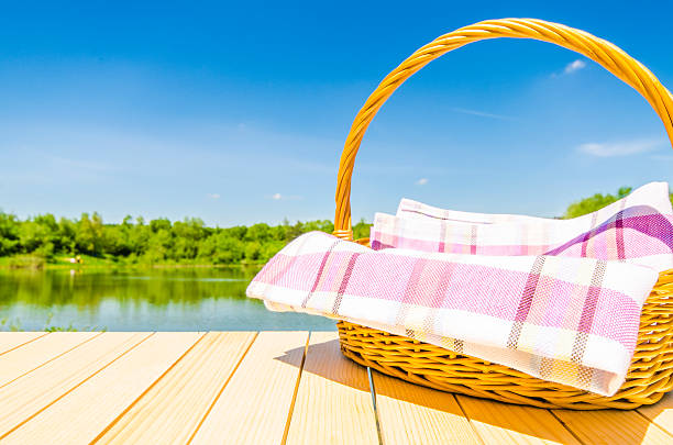 istock Picnic basket on wooden table with landscape background 501255854