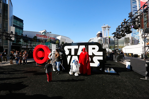 LOS ANGELES, California - December 12, 2015: A woman and child takes a selfie photo along with Star Wars characters at the Target/Star Wars experience at LA Live in the premiere week of Disney's Star Wars, The Force Awakens. This is a marketing set up in Downtown LA which will house the festivities before the movie's launch. Characters include: Darth Vader, Storm Troopers, R2D2, and the Imperial Guard.