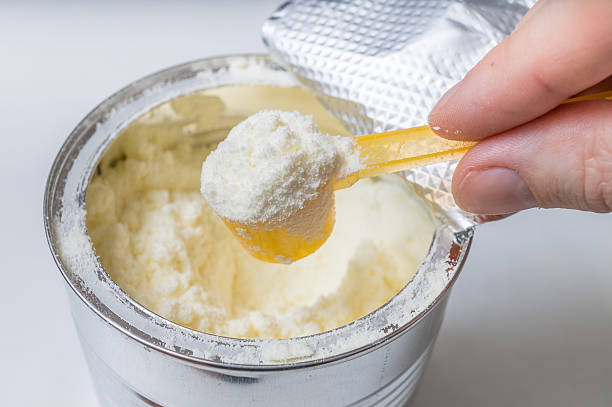 istock Hand holds scoop with newborn milk formula. 501256962
