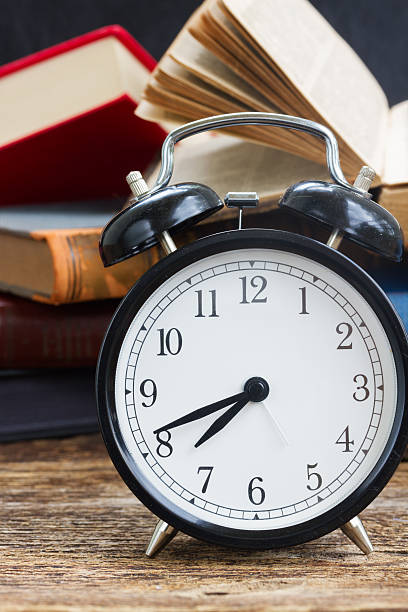istock pile of books with clock 501258350