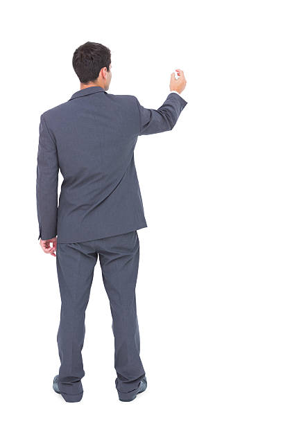 istock Businessman standing back to camera writing with marker 501259399