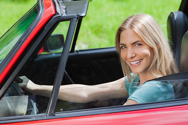 istock Cheerful woman driving red cabriolet 501260297