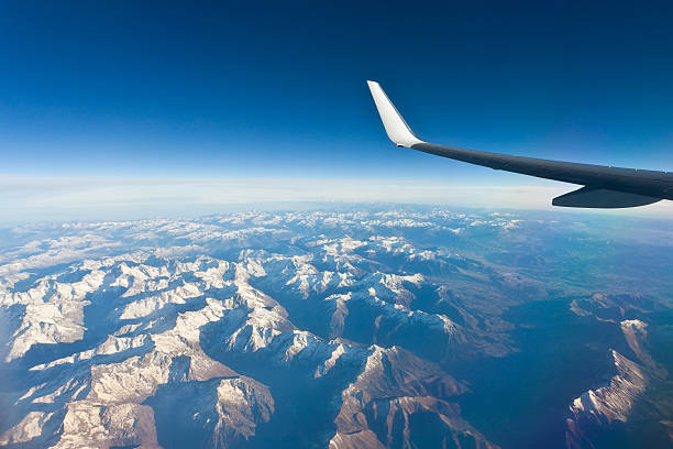 Airplane Wing in Flight above the mountain