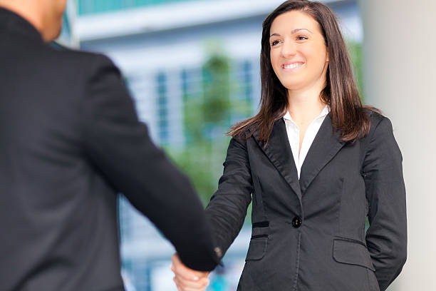 istock Businesspeople shaking hands outdoor 501261419