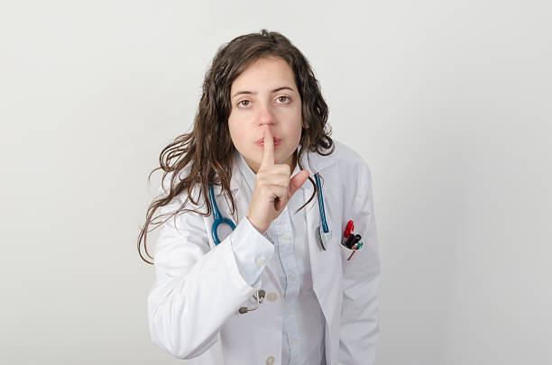 istock Young woman doctor asking for silence. 501261768