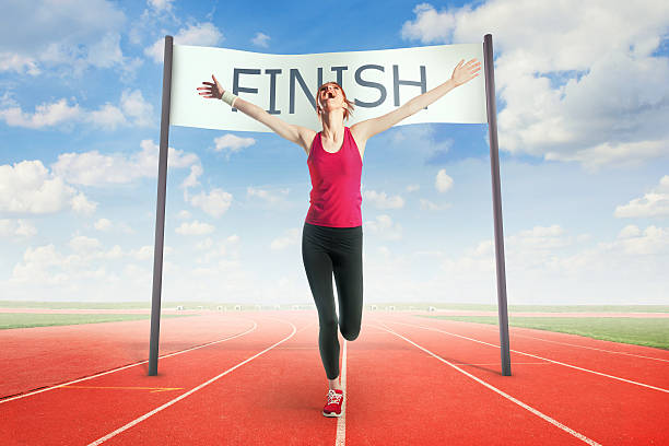 Woman crossing the finish line Woman crossing the finish line finish line photos stock pictures, royalty-free photos & images