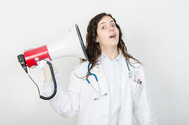 istock Young female doctor with megaphone. 501263166