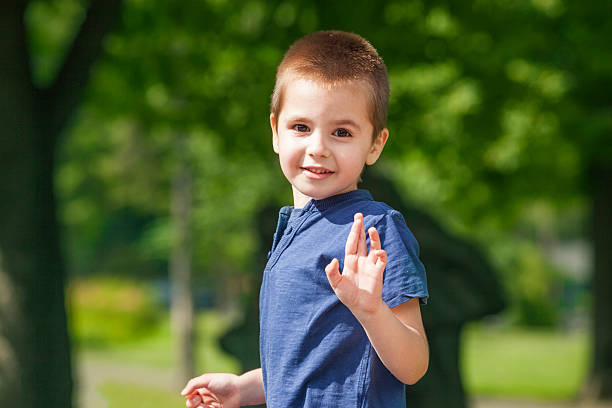 Cute little boy waving