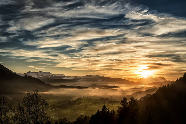 spectacular sunset over landscape at European alps in winter View from Allgäu in Germany (Obersdorf) over the Austrian Vorarlberg till to the Alpstein and Mountain Säntis in Switzerland in the background. snow sunset winter mountain stock pictures, royalty-free photos & images