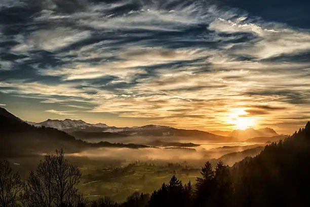 Photo of spectacular sunset over landscape at European alps in winter