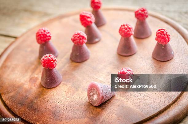 Cuberdons With Fresh Raspberries On The Wooden Board Stock Photo - Download Image Now