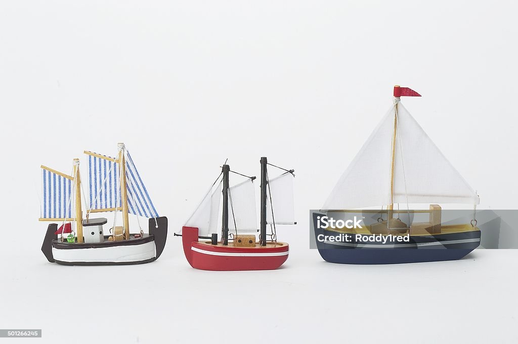 Wooden Toy Boats Three painted wooden toy boats on a white background. Toy Boat Stock Photo