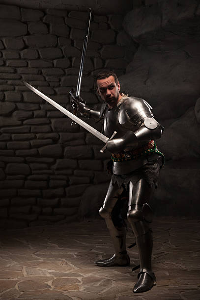 istock Medieval Knight posing with two swords on in a dark 501266379