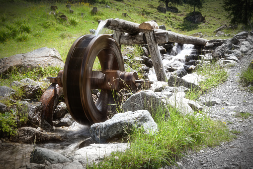 Mill wheel in the austrian mountain. Picture is toned.