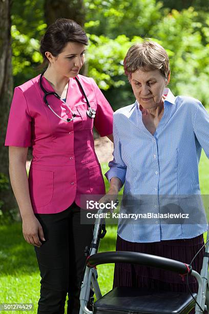 Woman With Walker In Garden Stock Photo - Download Image Now - Adult, Assistance, Care