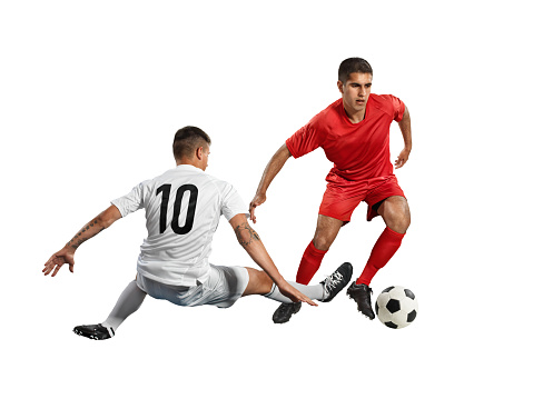 Dynamic portrait of young man, professional football player in motion, training, dribbling ball isolated over white studio background. Concept of sport, team game, action, motion. Copy space for ad