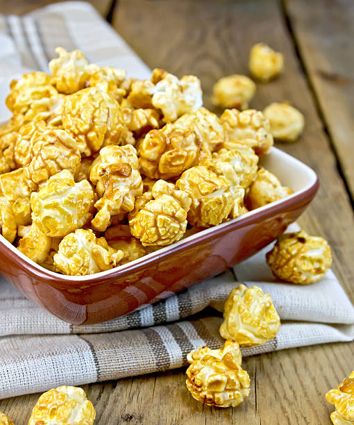 istock Popcorn caramel on board in clay bowl with napkin 501277385