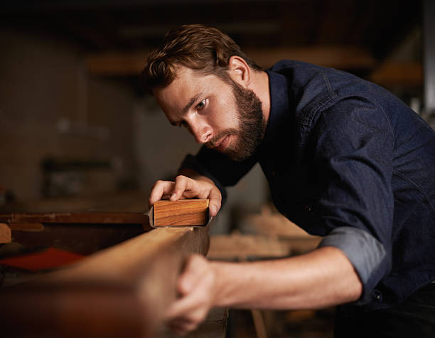 Since opportunity didn't knock, he decided to build a door Shot of a young artisan working intently in his workshophttp://195.154.178.81/DATA/i_collage/pi/shoots/783498.jpg rough and smooth stock pictures, royalty-free photos & images