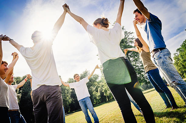 istock Friends holding hands in the park 501278933